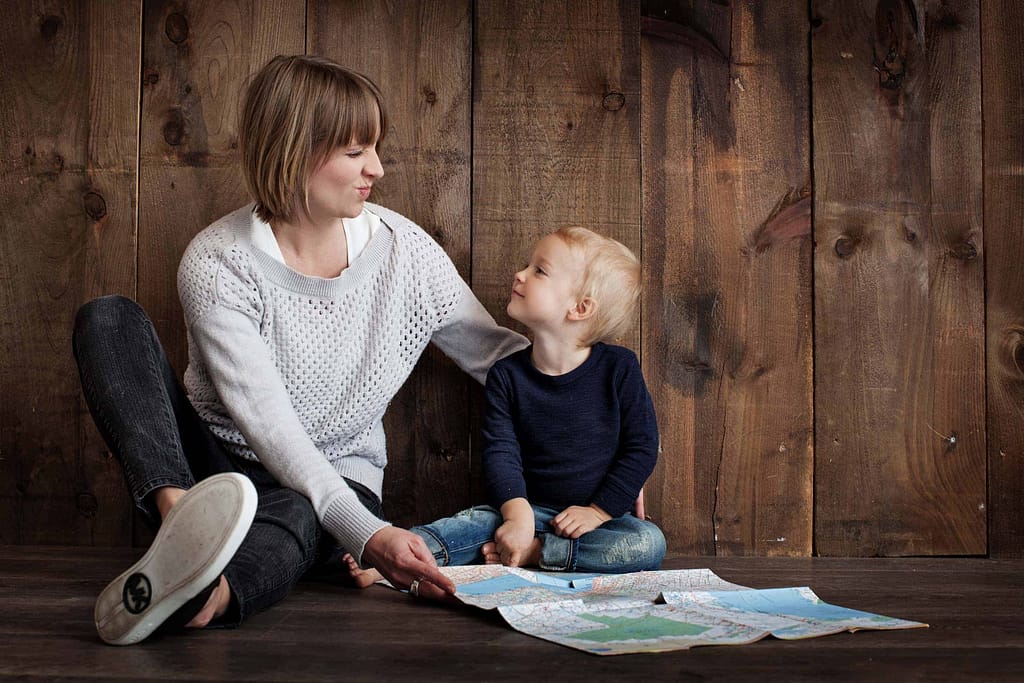 happy mum and kids sitting on the floor